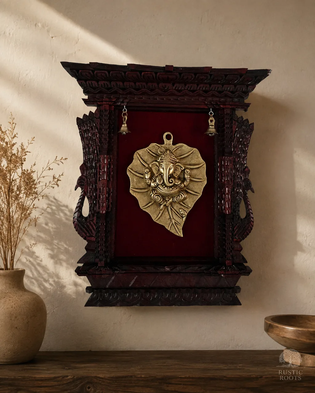 Brass Ganesh leaf wall plaque set in a carved timber frame